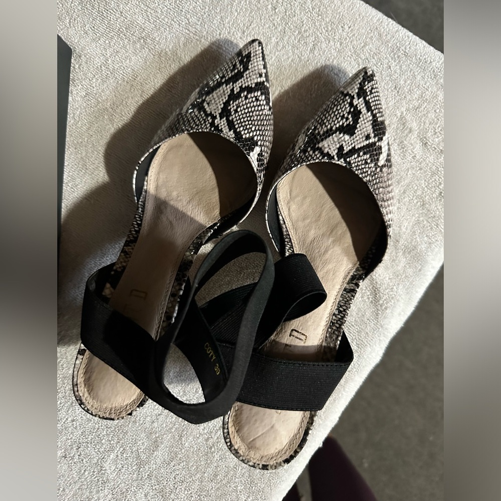 Silent D. Low sling heel.